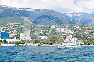 Views of the Crimean coastline with hotels and beaches with mountains in the background.