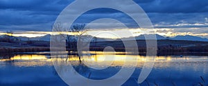 Views of Joshâ€™s Pond walking path, Reflecting Sunset in Broomfield Colorado surrounded by Cattails, plains and Rocky mountain la