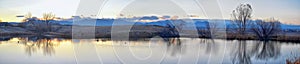 Views of Joshâ€™s Pond walking path, Reflecting Sunset in Broomfield Colorado surrounded by Cattails, plains and Rocky mountain la