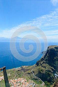 Views of Mount Teide, a village and a cliff from the glass interior of the Mirador de Abrante on the island of La Gomera. April 15