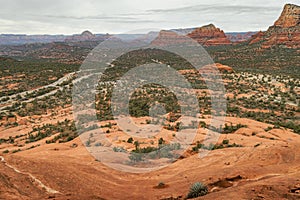 Views of red rock buttes and formations within coconino national forest in Sedona Arizona USA against white cloud background.