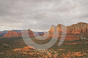 Views of red rock buttes and formations within coconino national forest in Sedona Arizona USA against white cloud background.