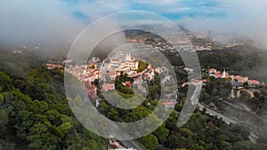 Views of Sintra city, Portugal, shot from a drone on a foggy morning. Sintra National Palace.