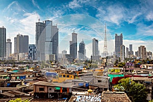 Views of slums on the shores of mumbai, India against the backdrop of skyscrapers under construction