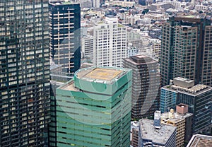 Views of Tokyo city buildings, and a helipad ontop of a building