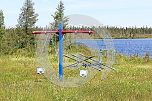 Views of an unmaintained playground by a lake