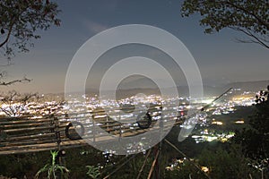 views of village lights on the mountain and bamboo boat reflections