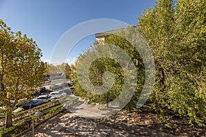 Views from the window of a house with leafy trees on a clear autumn day