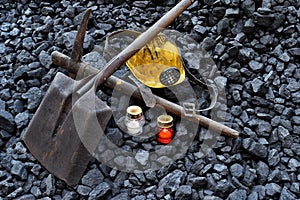 Vigil light, candle with the miner belongings helmet, pickaxe, shovel, belt