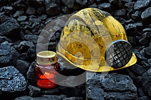 Vigil light, candle with mining helmet on cheap of coal