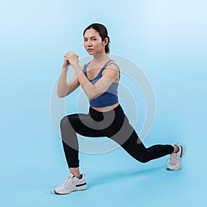 Vigorous energetic woman doing exercise with squat on isolated background.