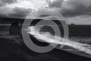 The Vik beach in black and white under dramatic sky, Iceland