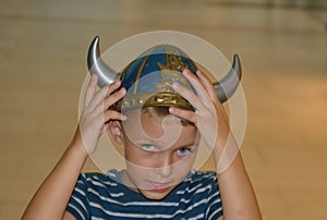 Viking boy with the hands on the helmet