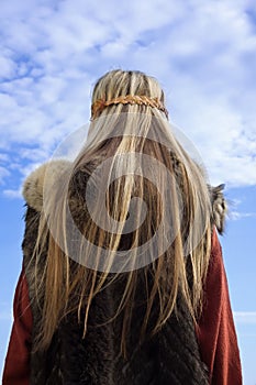 Viking girl on a blue sky background