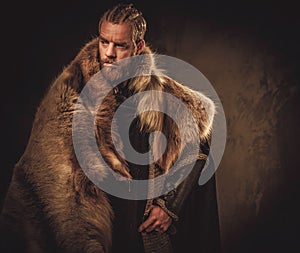 Viking konung in a traditional warrior clothes