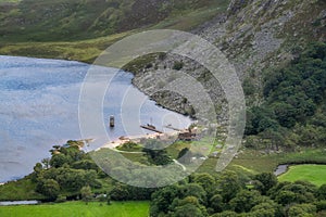 Viking longships moored on a dock, village at the Guiness Lake in Wicklow Mountains