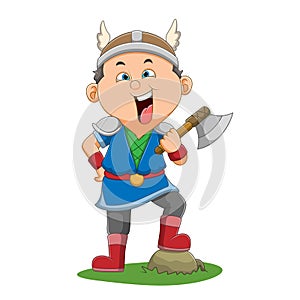 The viking man is holding an axe on his left hand and stepping on a rock