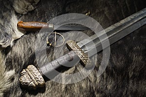 Viking sword and knife on a fur