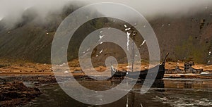 Viking village in Iceland with longboat and reflections