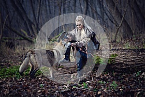 Viking warrior female with a wolf in the forest - Cinematic medieval scene photo