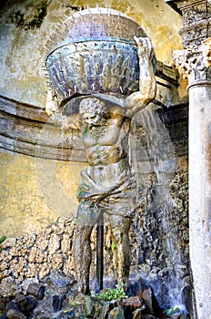 Villa Aldobrandini in Frascati. Detail of the Water Theater, The mythological figure of Atlas holfind the globe. Lazio, Italy.
