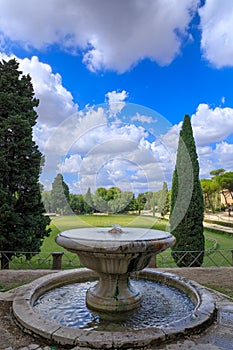 Villa borghese Garden in Rome, Italy: view of Puppet Fountain with Piazza di Siena in the background.