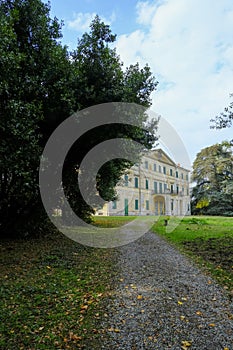 Villa Casino dei Boschi across the green meadow and dramatic sky. Boschi di Carrega, Emilia-Romagna, Italy photo