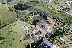 Villa Cordevigo with swimming pool surrounded by trees and vineyards. Verona, Italy. Drone