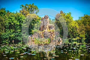 Villa Demidoff Pratolino park and the Colosso del Appennino colossus statue with pond full of waterlilies and leaves photo