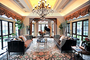 Villa living room surrounded by large windows