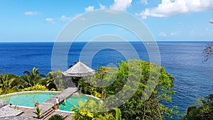 Villa near the Caribbean Sea, a man cleans the pool