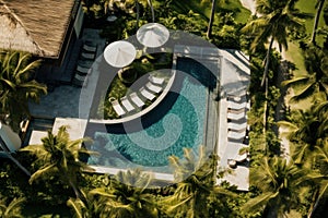 Villa with pool and palm trees, a tropical seaside resort.