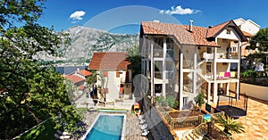 Villa with terraces, a trampoline in the yard and a swimming pool in the garden against the backdrop of the mountains