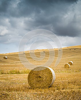 Villa on top of hill overlooks recently harvested hay bales