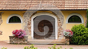 Villa wooden Doorway with stones and flowerpots