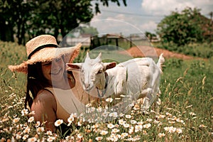 Village animals. Happy pregnant woman hugs goat, concept of unity of nature and man. Life in the countryside.