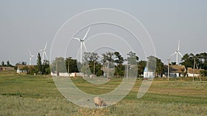 Village on the background of wind turbines