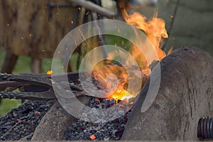 Village Blacksmith near bellows and anvil at work