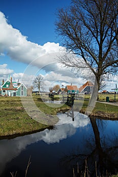 Village with blue sky reflecting in pond