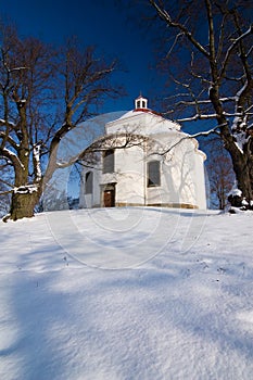 Village chapel in winter countryside photo