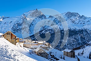 Village of Chazelet facing La Meije peak and glacier Ecrins National Park Massif in winter. Alps, France