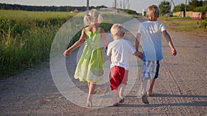 Village children run along the road in the evening.