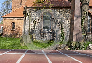 A village church near Berlin with weathered grave crosses