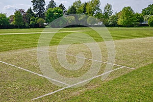 Village cricket pitch, freshly prepared with batting and bowling crease marked out. photo