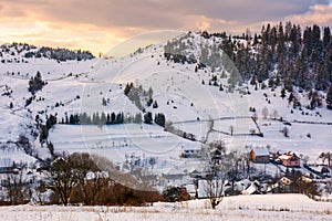 Village down the hill on winter sunset