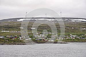 Village and electric wind mills on Barents sea,  Batsfjord, Norway