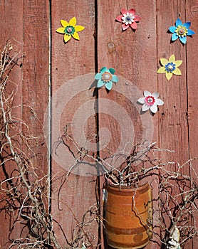 In the village garden installation dry branches and homemade plastic flowers are used.