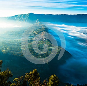 Village on highland with fog during sunrise