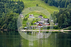 Village on a hill near a lake, alps mountains, Austria