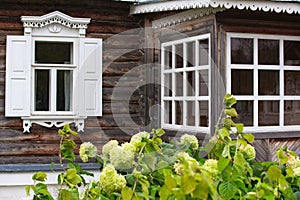 a village house , a window with platbands in the wall of a house